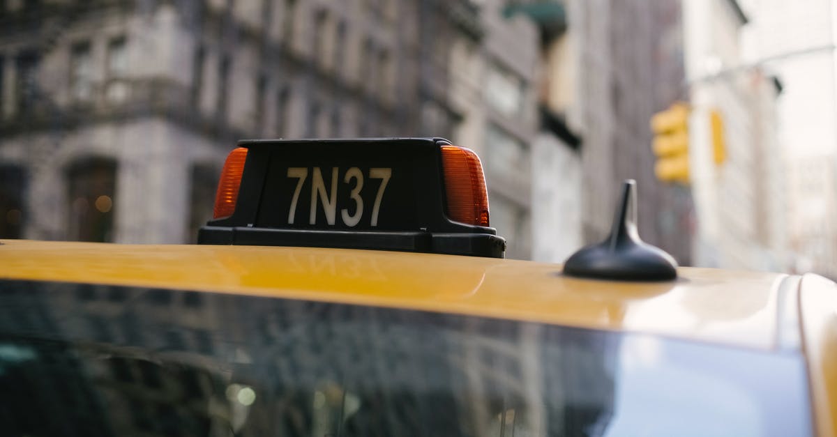 EU roaming when calling a number outside the EU? - Sign on roof of yellow cab with numbers and letter located in city on street with residential buildings on blurred background EU roaming when calling a number outside the EU? - Sign on roof of yellow cab with numbers and letter located in city on street with residential buildings on blurred background