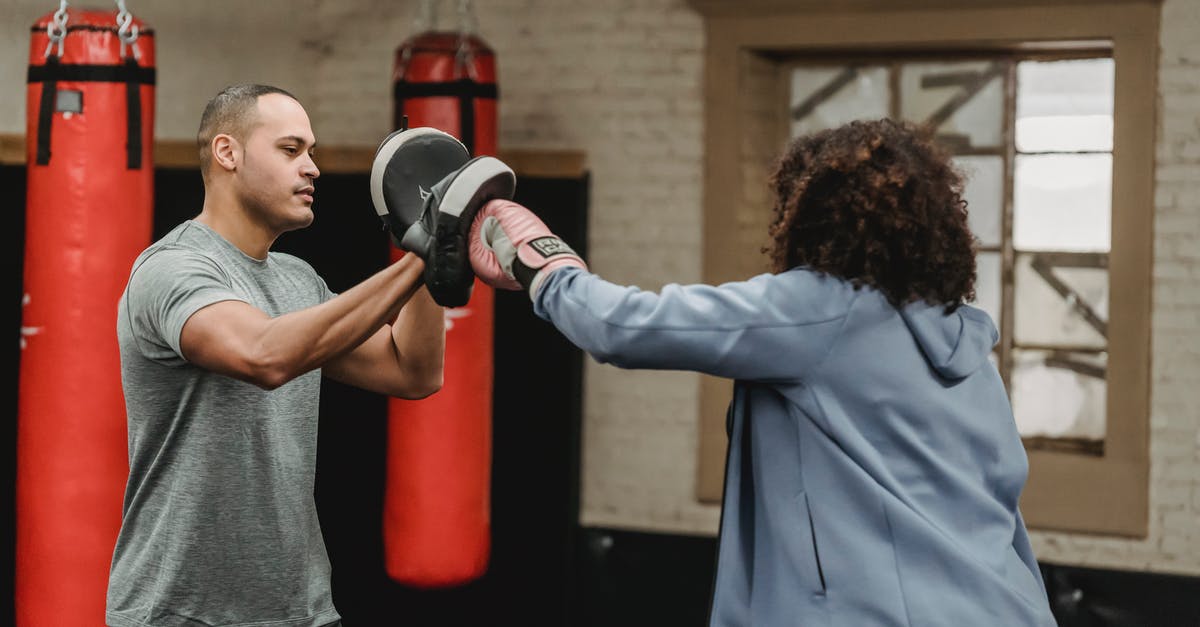 Eurostar train to Paris during a strike - Ethnic trainer working out with unrecognizable boxer in gym Eurostar train to Paris during a strike - Ethnic trainer working out with unrecognizable boxer in gym