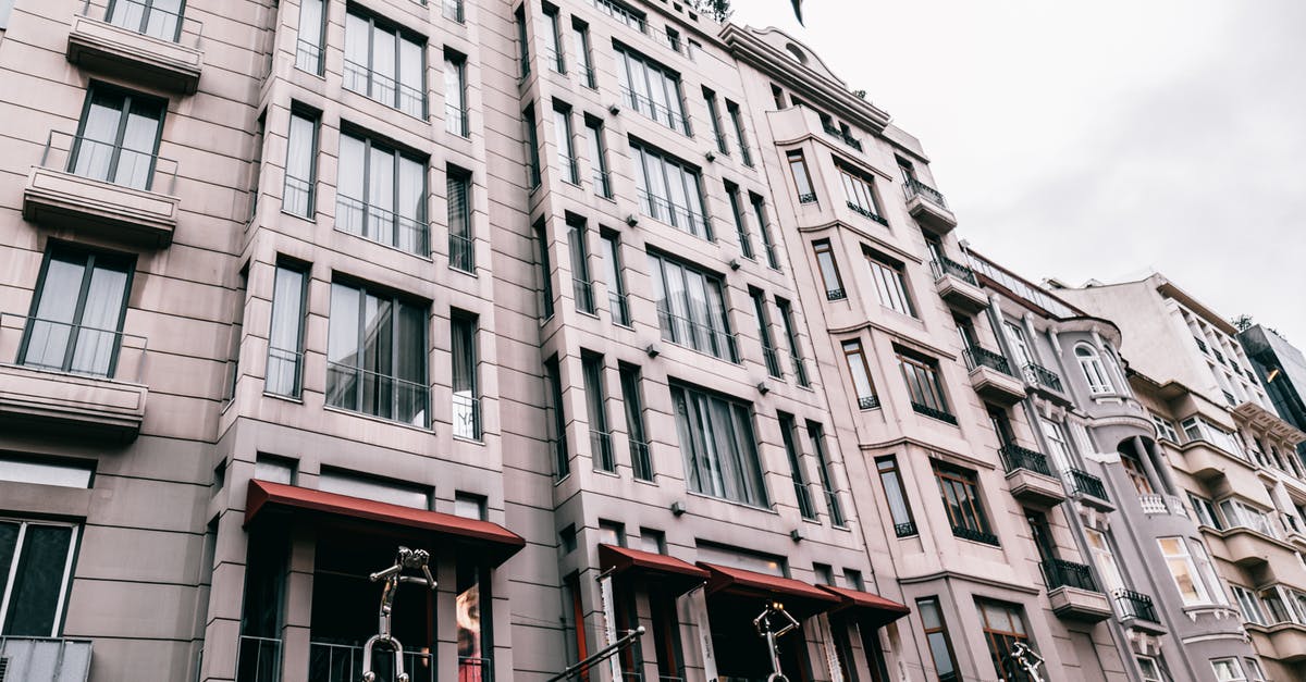 E-visa for 20hr layover at Istanbul airport, is hotel reservation necessary? - From below of contemporary residential building decorated with figures located on street of Istanbul
