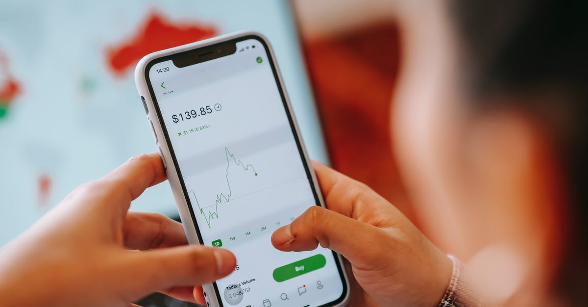 Exchanging and using Scottish pounds - Crop dealer touching screen on smartphone with trading application Exchanging and using Scottish pounds - Crop dealer touching screen on smartphone with trading application
