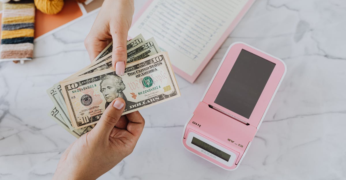 Exchanging Dollars for Yuan - Hands Holding Dollars Exchanging Dollars for Yuan - Hands Holding Dollars