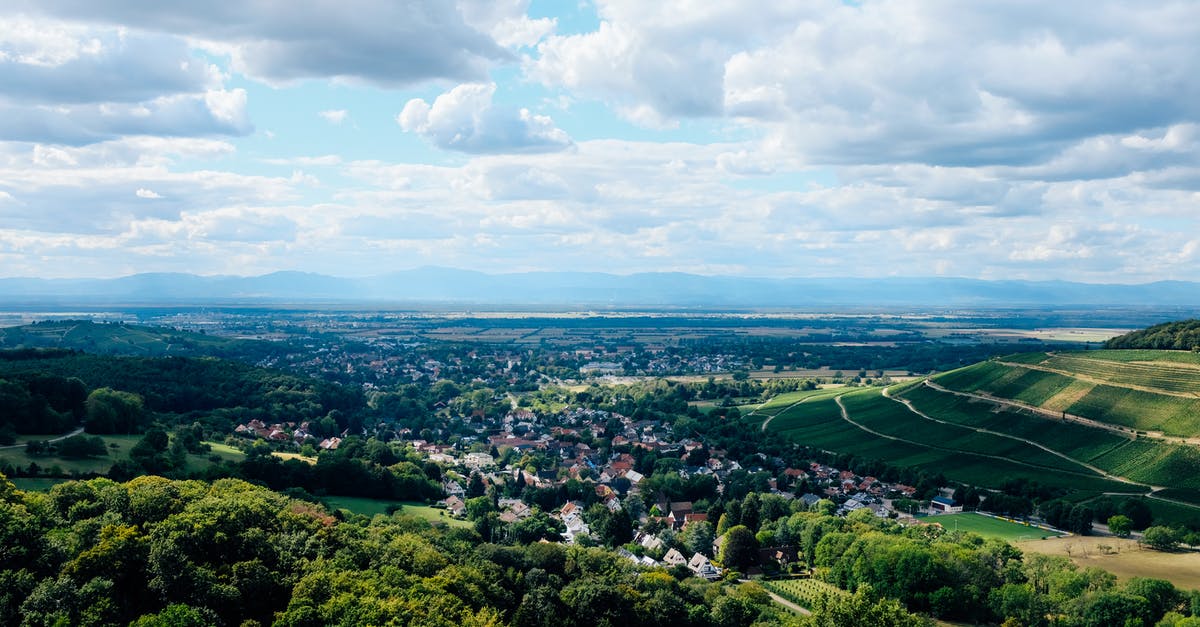 Exit and re-enter Schengen area if country that issued the visa is the final destination - Modern town located on grassy lush valley Exit and re-enter Schengen area if country that issued the visa is the final destination - Modern town located on grassy lush valley