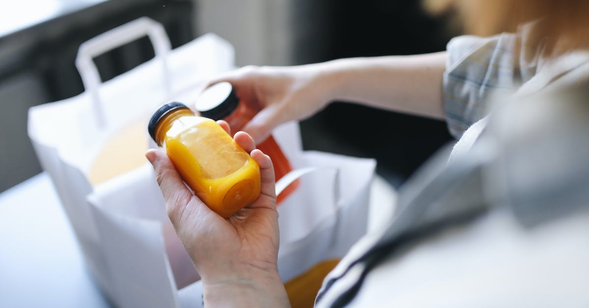 Expanding items? - Person Holding Orange Plastic Bottle Expanding items? - Person Holding Orange Plastic Bottle