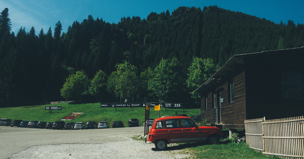 Exploring Switzerland with a car - where can I park? - Red 5-door Hatchback Near the Brown Wooden House in Daytime Exploring Switzerland with a car - where can I park? - Red 5-door Hatchback Near the Brown Wooden House in Daytime
