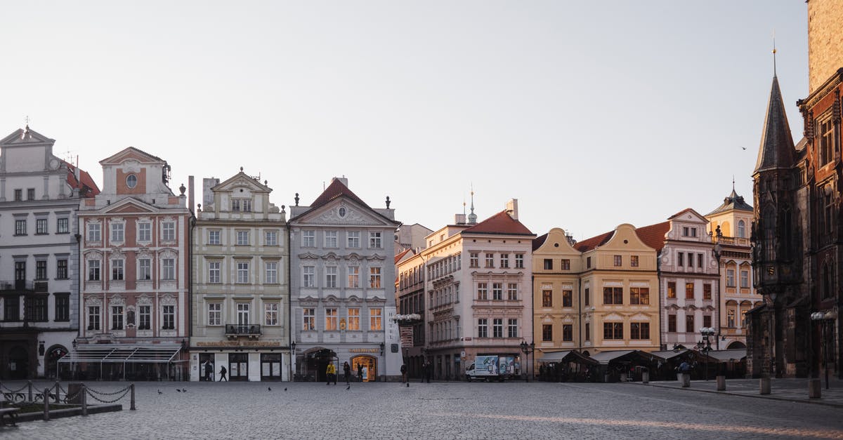 Extending stay in Schengen area as I'm about to get European citizenship [closed] - Old fashioned historic bright residential houses lined up next to each other on paved spacious street in city against cloudless sky