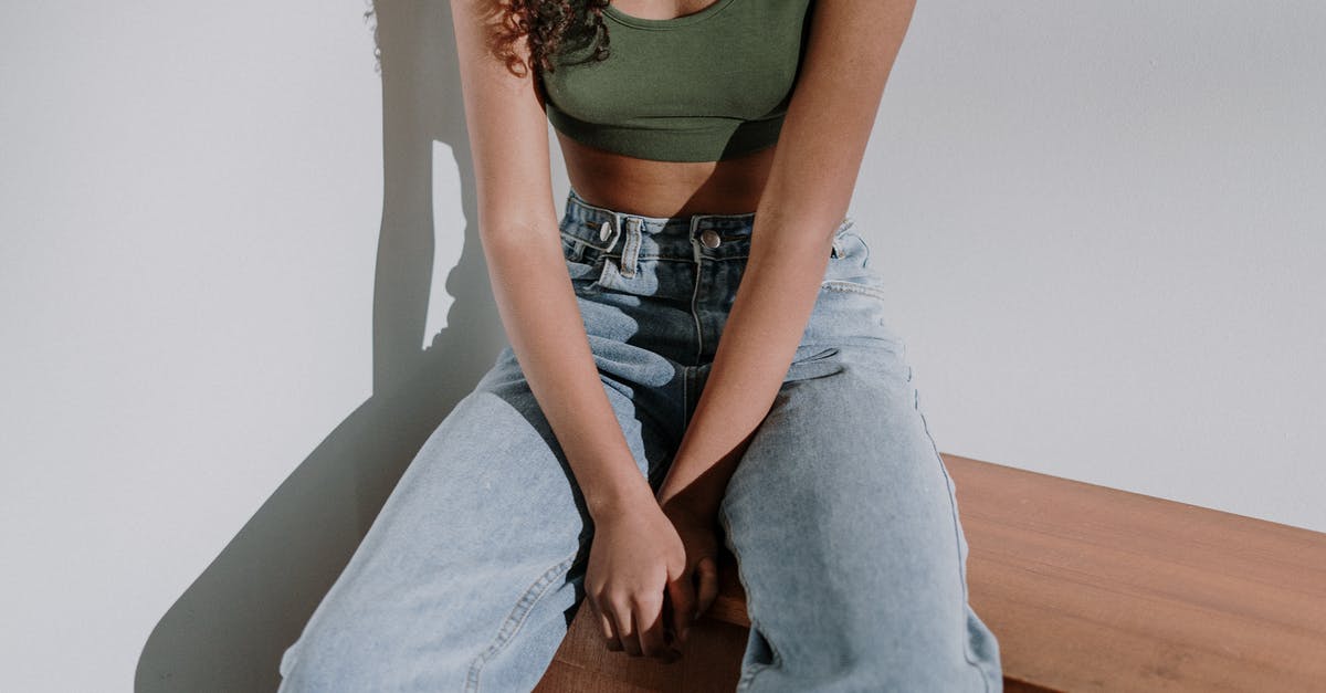 Extending Visa from Philipines bureau of Imigration - Woman in Green Tank Top and Blue Denim Jeans Sitting on Brown Wooden Chair Extending Visa from Philipines bureau of Imigration - Woman in Green Tank Top and Blue Denim Jeans Sitting on Brown Wooden Chair
