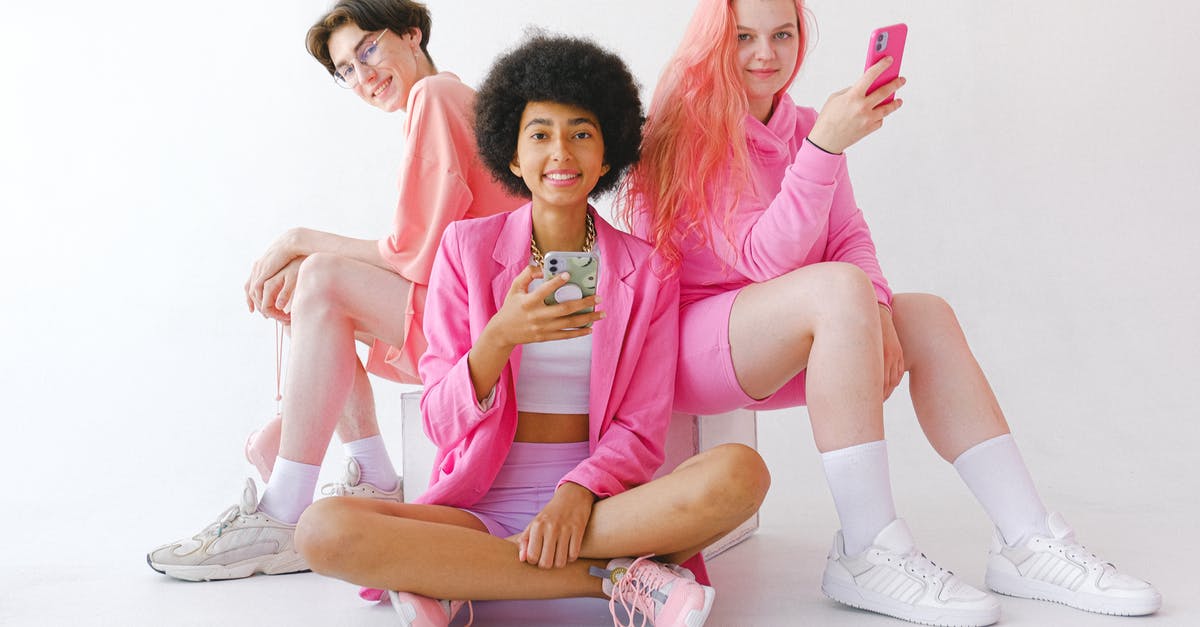 Extraordinary circumstances, missed connections and overnight stays - Cheerful multiracial teenagers in trendy outfit with smartphones Extraordinary circumstances, missed connections and overnight stays - Cheerful multiracial teenagers in trendy outfit with smartphones