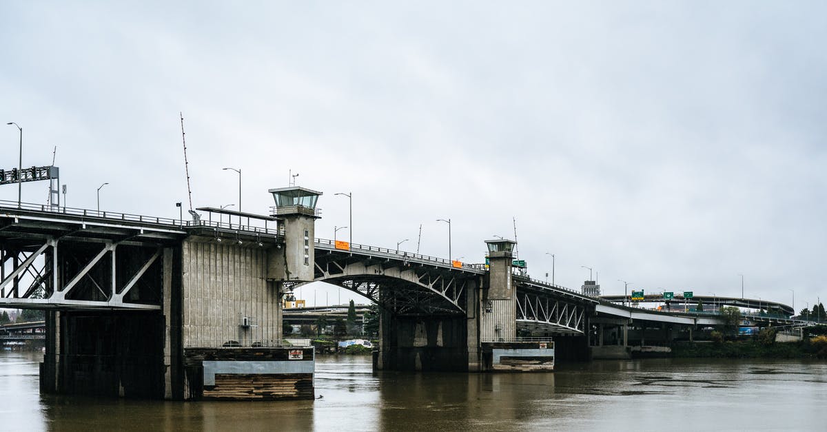 F1 / OPT / ESTA for USA - Gray Concrete Bridge over River Under White Sky F1 / OPT / ESTA for USA - Gray Concrete Bridge over River Under White Sky