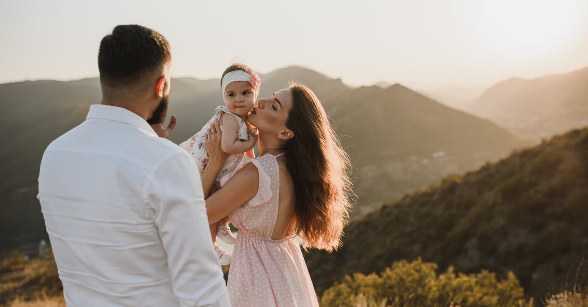 Family permit UK - Daughter Kissing Baby Daughter on Top of Hill Family permit UK - Daughter Kissing Baby Daughter on Top of Hill