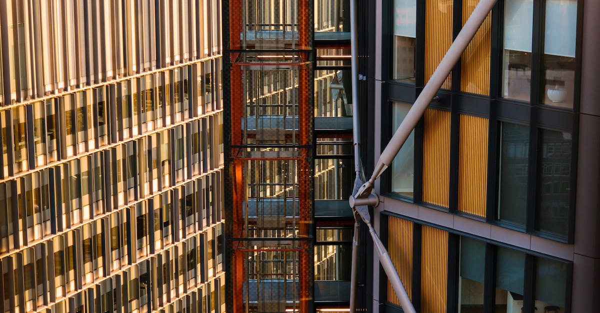 Fastest public elevator in the world - Contemporary multistage houses with beams and creative design located between modern elevator with black grid on sunny street of city Fastest public elevator in the world - Contemporary multistage houses with beams and creative design located between modern elevator with black grid on sunny street of city