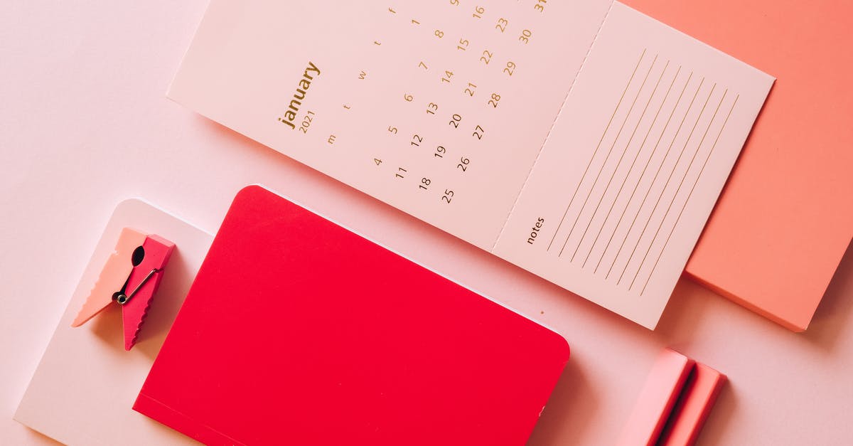 Ferries in January in the Azores - Layout of calendar paper with notes on bright multicoloured notebooks on pink background Ferries in January in the Azores - Layout of calendar paper with notes on bright multicoloured notebooks on pink background