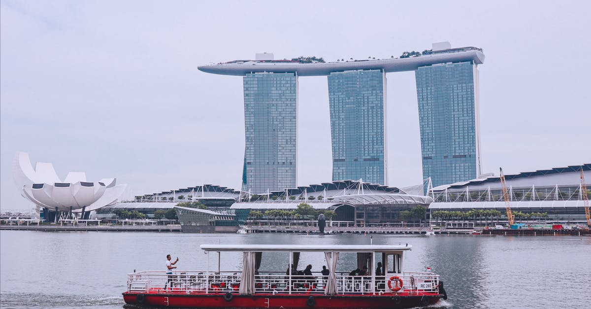 Ferry services between Singapore and Borneo - White and Red Boat in the Water Ferry services between Singapore and Borneo - White and Red Boat in the Water