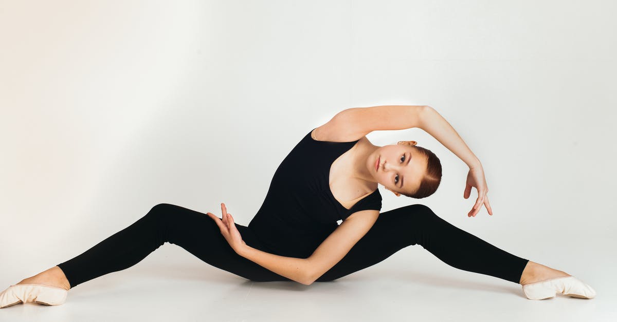 finding flights with flexible origination points [duplicate] - Young flexible female in black outfit and pointes stretching while practicing yoga and looking at camera in studio on white background