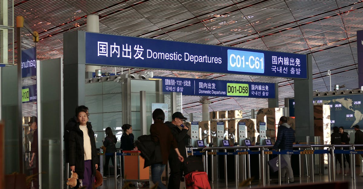 Finding local train ticket agents/offices in China. - People Walking on the Sidewalk Finding local train ticket agents/offices in China. - People Walking on the Sidewalk