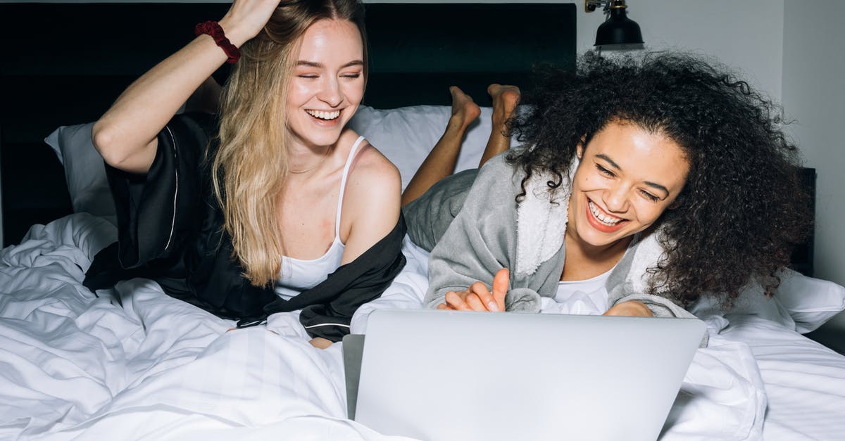 Finding sleepover spots in internet cafes in Japan? - Two Young Women Having Fun While Looking at a Laptop