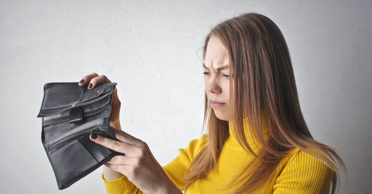 Finding the "Airport Express Shuttle Bus" at Hong Kong station? - Woman Holding Black Wallet Finding the "Airport Express Shuttle Bus" at Hong Kong station? - Woman Holding Black Wallet