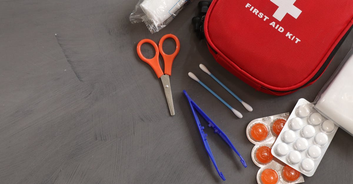 First aid scissors confiscated by Dubai airport security - First Aid Kit on Gray Background First aid scissors confiscated by Dubai airport security - First Aid Kit on Gray Background