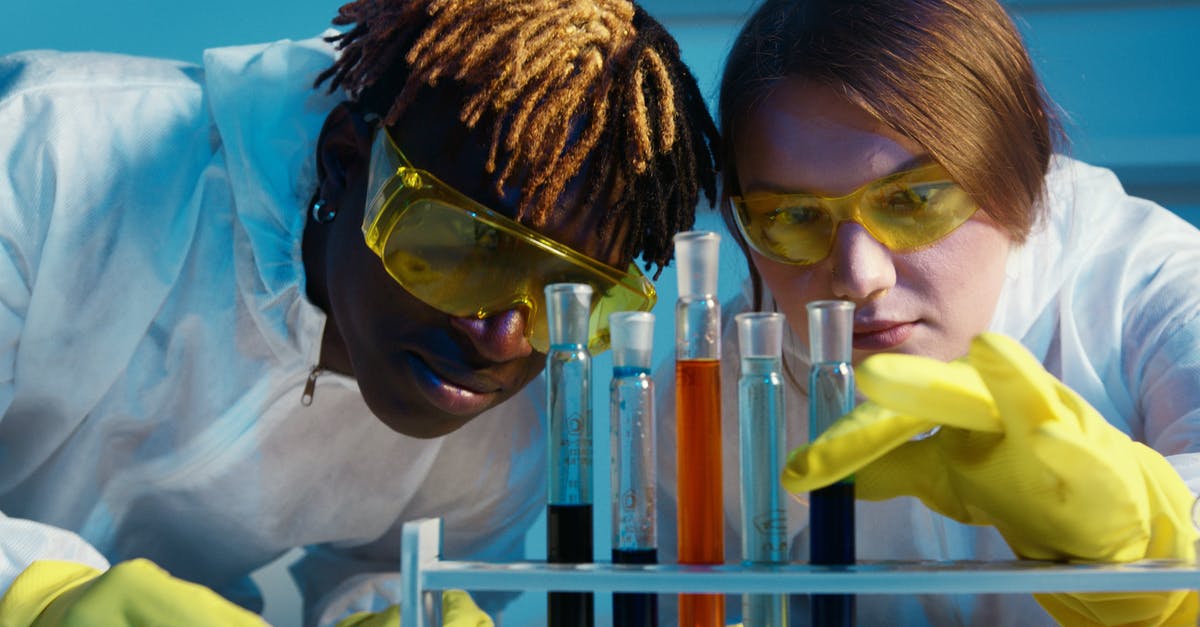 Flight safety and liquid chemicals: 95% alcohol and formol - A Man and a Woman Looking at the Test Tubes Flight safety and liquid chemicals: 95% alcohol and formol - A Man and a Woman Looking at the Test Tubes