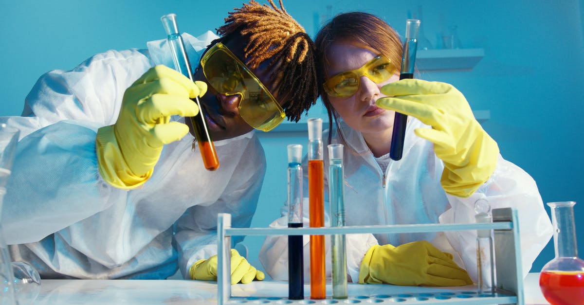 Flight safety and liquid chemicals: 95% alcohol and formol - A Man and a Woman Holding a Test Tube Flight safety and liquid chemicals: 95% alcohol and formol - A Man and a Woman Holding a Test Tube