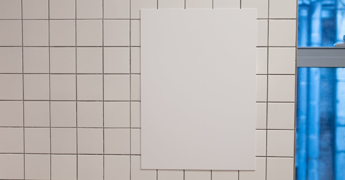 Flights info for Choluteca? - Blank white placard hanging on wall covered with white tiles inside of building Flights info for Choluteca? - Blank white placard hanging on wall covered with white tiles inside of building