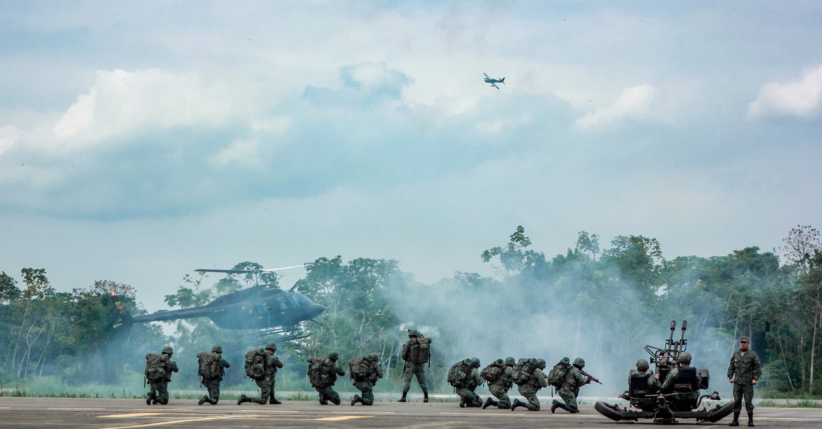 Flying company delayed luggages on professional mission [closed] - Unrecognizable soldiers with infantry weapons accomplishing military mission near helicopter