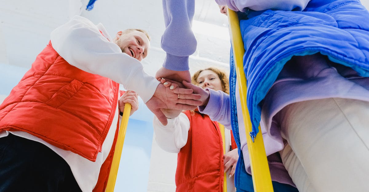 Flying company delayed luggages on professional mission [closed] - From below of satisfied curling players spreading hands and joining palms together during game