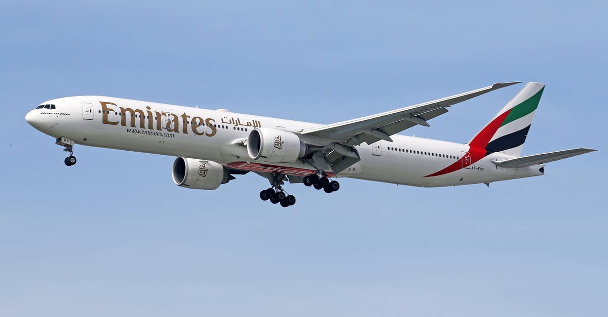 Flying with Emirates and confused about luggage - White and Red Passenger Plane in the Sky Flying with Emirates and confused about luggage - White and Red Passenger Plane in the Sky