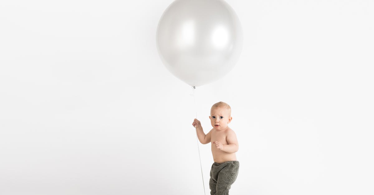 Flying with someone else's children - Baby Holding White Balloon Flying with someone else's children - Baby Holding White Balloon
