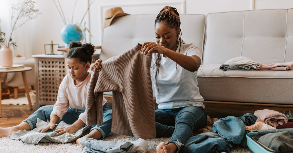 Folding strollers allowed as hand baggage on Norwegian? - Woman and Child Holding Clothes Together Folding strollers allowed as hand baggage on Norwegian? - Woman and Child Holding Clothes Together
