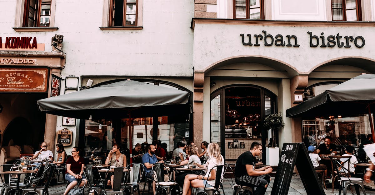 Food Allergies in Europe - Street cafe with people and tables Food Allergies in Europe - Street cafe with people and tables