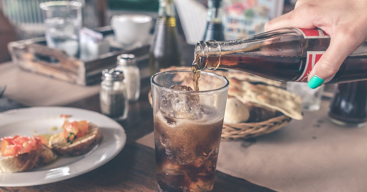 Food Allergies- Precooked/frozen meals to Netherlands - Photo of Cola Pouring Into a Glass with Ice Cubes Food Allergies- Precooked/frozen meals to Netherlands - Photo of Cola Pouring Into a Glass with Ice Cubes