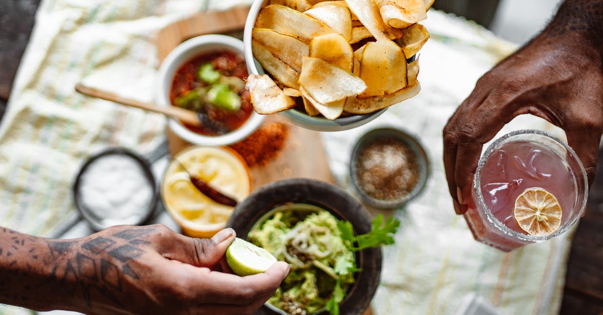 Food Allergies- Precooked/frozen meals to Netherlands - Three Unrecognizable Hands Holding Chips Lime and Cold Fruit Drink Food Allergies- Precooked/frozen meals to Netherlands - Three Unrecognizable Hands Holding Chips Lime and Cold Fruit Drink