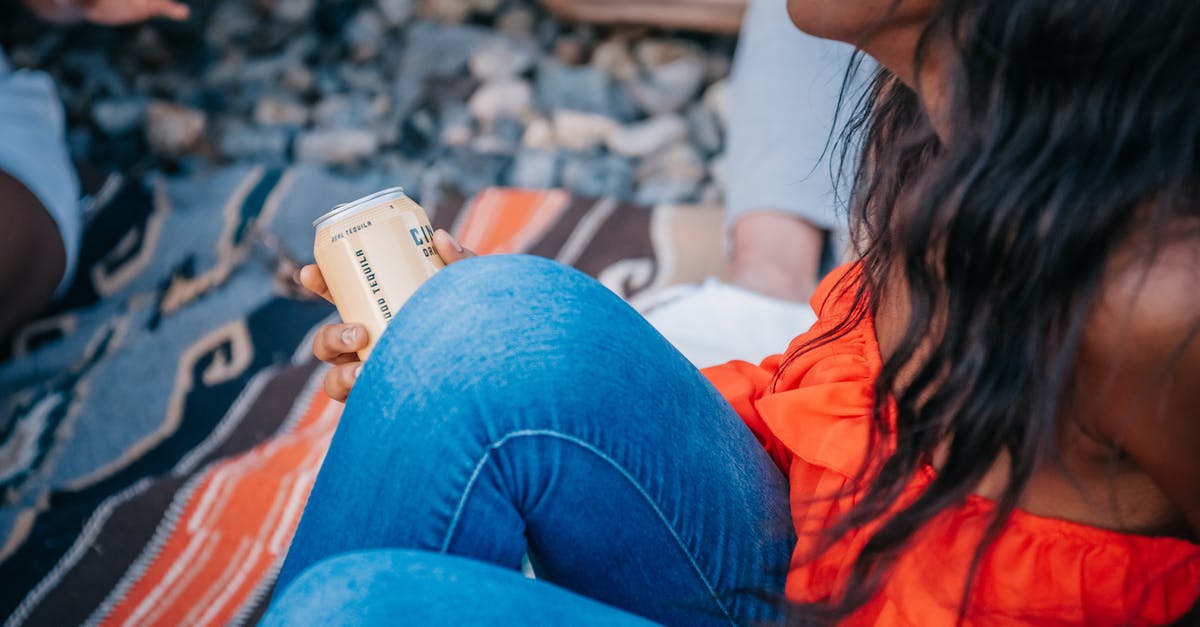 For Germany, can I apply for a long-term visa while holding a short-term one? [closed] - Woman in Orange Top Holding a Can