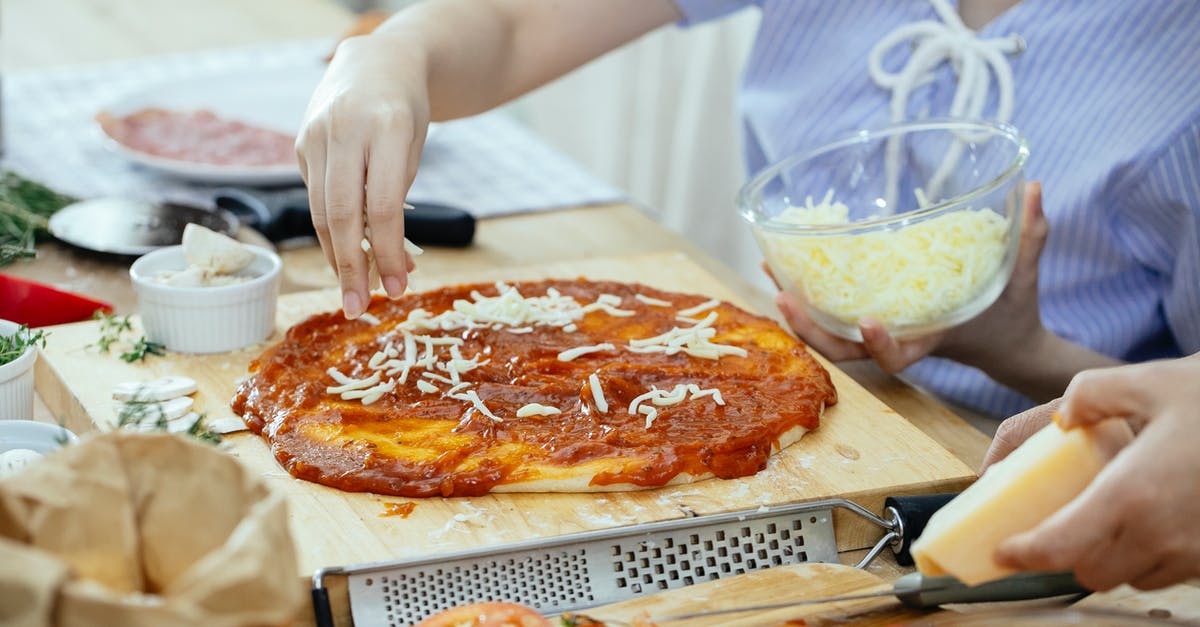 Forget to add a guest in non-free cancellation booking in booking.com - Woman sprinkling cheese on pizza Forget to add a guest in non-free cancellation booking in booking.com - Woman sprinkling cheese on pizza