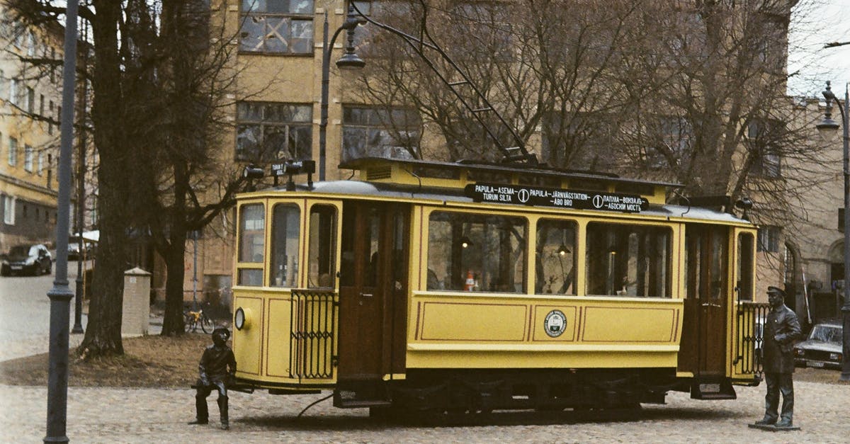 Former Gulag camps in Russia - Yellow and Black Tram on Road Near Bare Trees Former Gulag camps in Russia - Yellow and Black Tram on Road Near Bare Trees