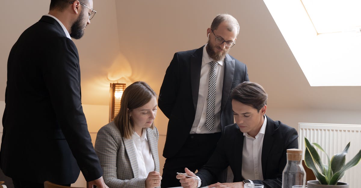 France Business Visa For Attending OpenSource Conference - Man in Black Suit Jacket Sitting Beside Woman in Gray and White Long Sleeve Shirt France Business Visa For Attending OpenSource Conference - Man in Black Suit Jacket Sitting Beside Woman in Gray and White Long Sleeve Shirt