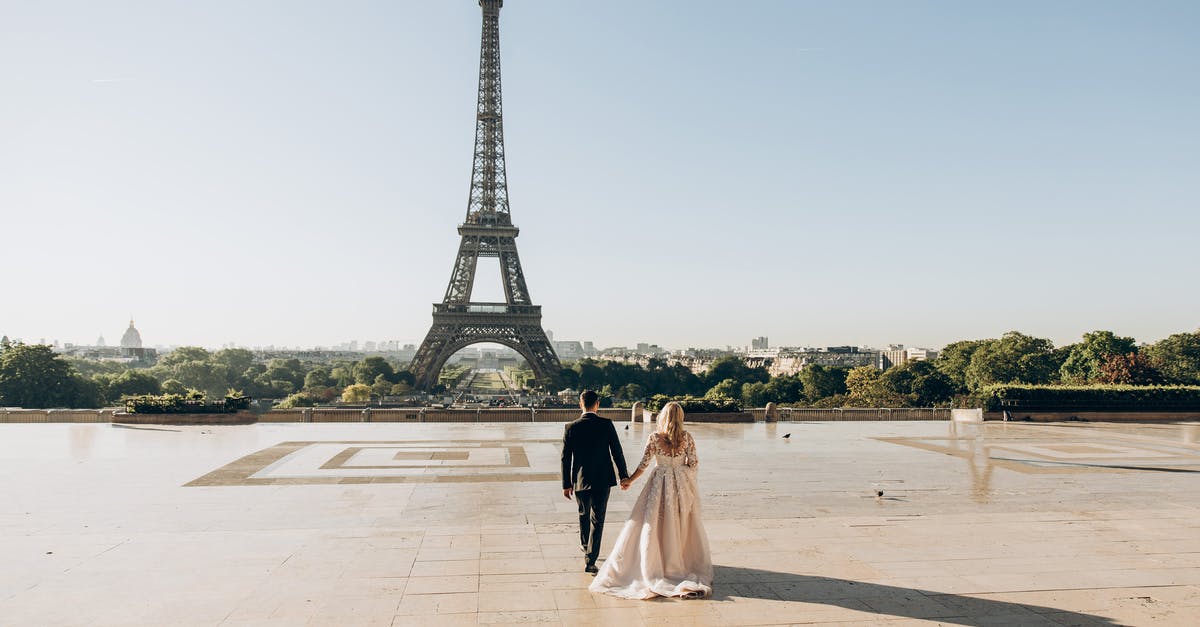 France visa for one day - Woman and Man Walking in Park in Front of Eiffel Tower France visa for one day - Woman and Man Walking in Park in Front of Eiffel Tower