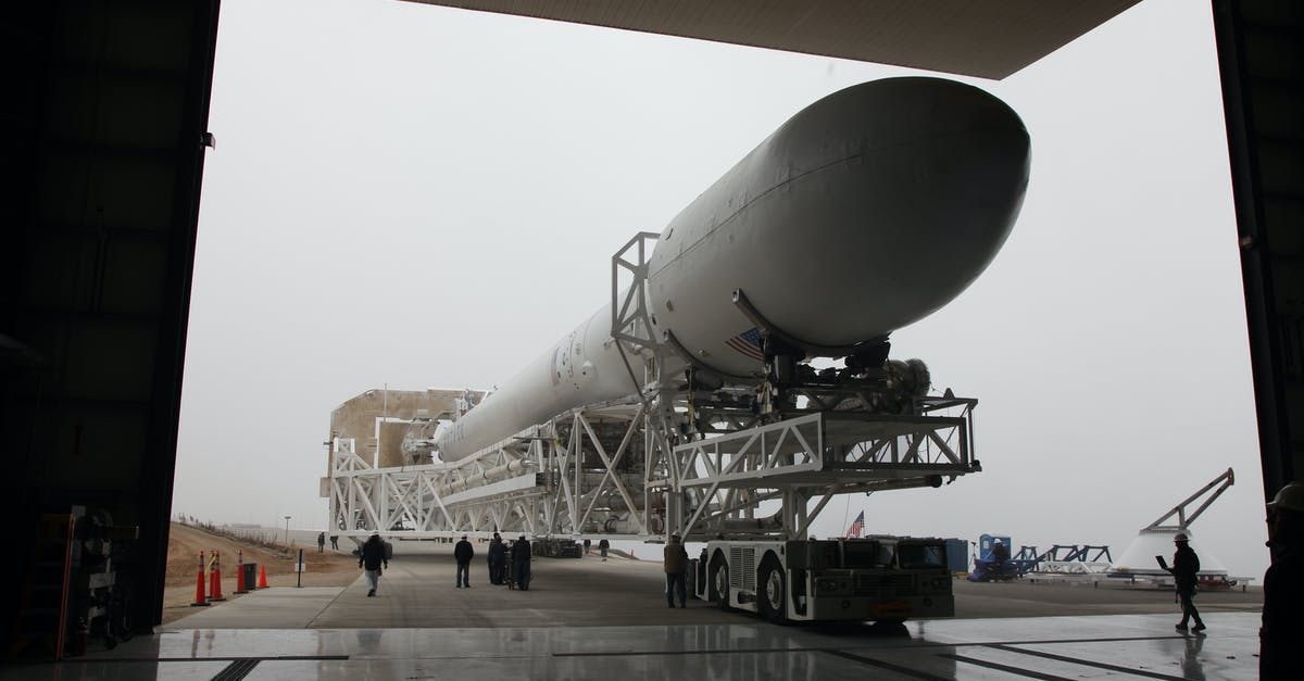 Free bus shuttle service from Hong Kong airport? - New installed rocket booster placed on transporter platform and moving into vehicle assembly building in space center on cloudy day Free bus shuttle service from Hong Kong airport? - New installed rocket booster placed on transporter platform and moving into vehicle assembly building in space center on cloudy day