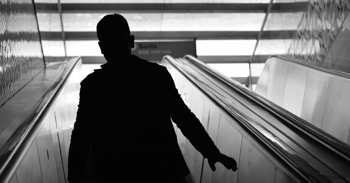 Frequent business travel to Schengen region - which visa do I go for? - Man Walking on Escalator