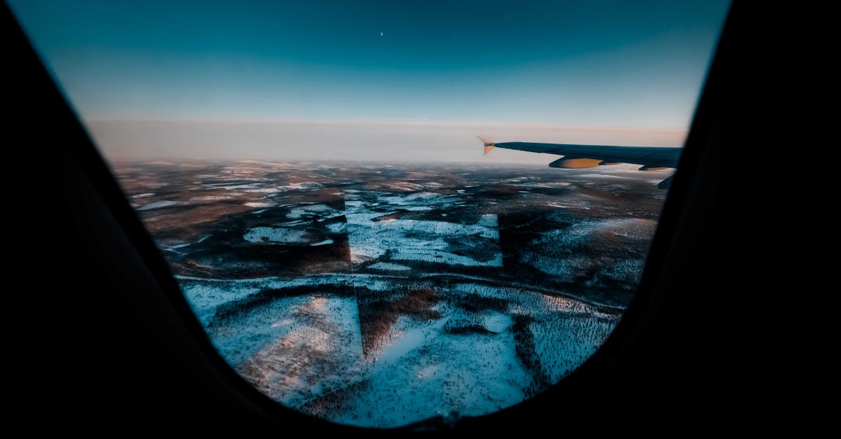 From Canada to Norway, through the North Pole, is that possible? - Aircraft flying above snowy land under blue sky From Canada to Norway, through the North Pole, is that possible? - Aircraft flying above snowy land under blue sky