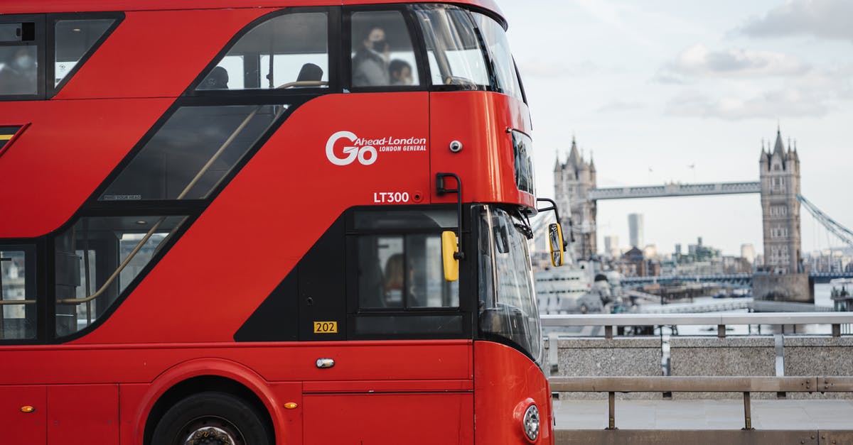 From Gatwick airport to central London by bus - Modern bus driving along river against bridge From Gatwick airport to central London by bus - Modern bus driving along river against bridge
