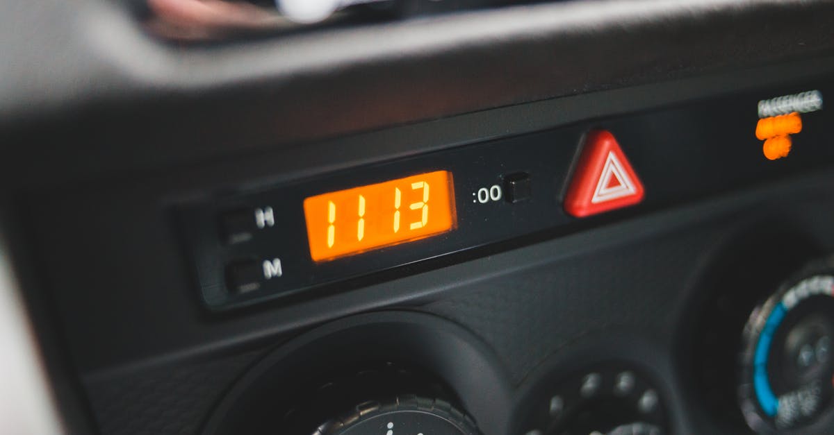 From JFK to Newark. Time & transportation alternatives - Electronic clock on dashboard of car From JFK to Newark. Time & transportation alternatives - Electronic clock on dashboard of car