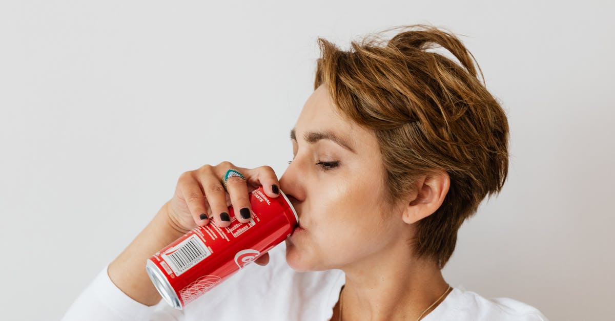 From where in Ethiopia can I see the Red Sea? - Thirsty woman enjoying coke from colorful can From where in Ethiopia can I see the Red Sea? - Thirsty woman enjoying coke from colorful can