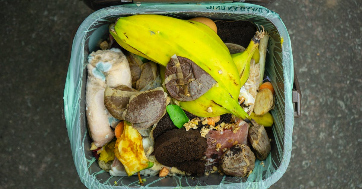 Garbage bin on Khao San Road, Bangkok - Banana Fruit and Meat in Blue Plastic Container Garbage bin on Khao San Road, Bangkok - Banana Fruit and Meat in Blue Plastic Container