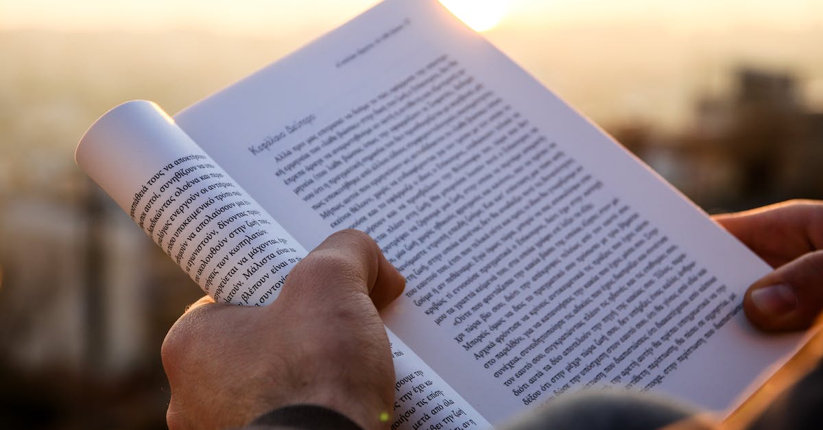 Genova palaces and Greek Gods [closed] - Person Holding a Book During Sunset