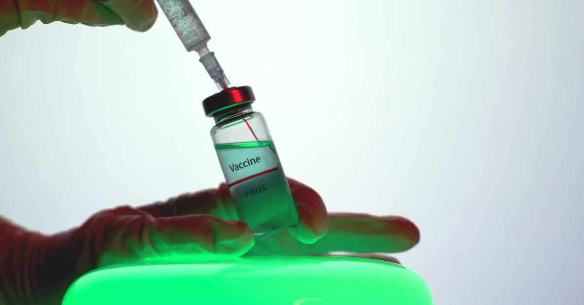 Get 2nd dose of COVID vaccine in the US as a tourist - Person Aspirating the Vaccine from the Vial Get 2nd dose of COVID vaccine in the US as a tourist - Person Aspirating the Vaccine from the Vial