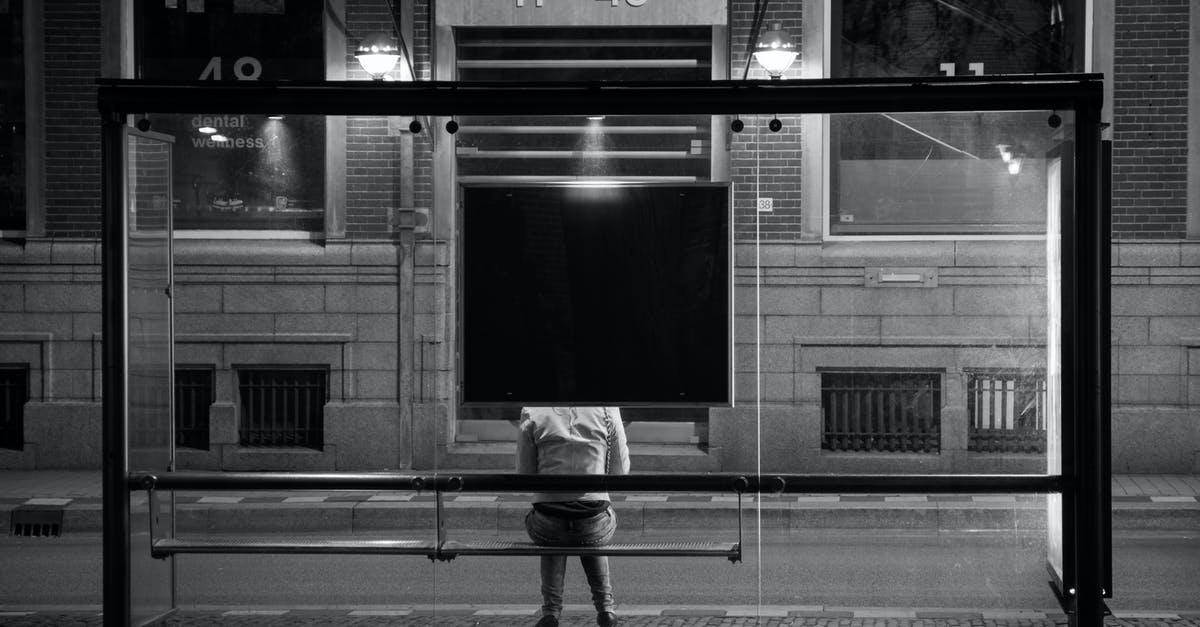 Getting back to Brussels from Sint-Truiden with public transportation on a friday night - Grayscale Photography of Person Sitting on Shed Getting back to Brussels from Sint-Truiden with public transportation on a friday night - Grayscale Photography of Person Sitting on Shed