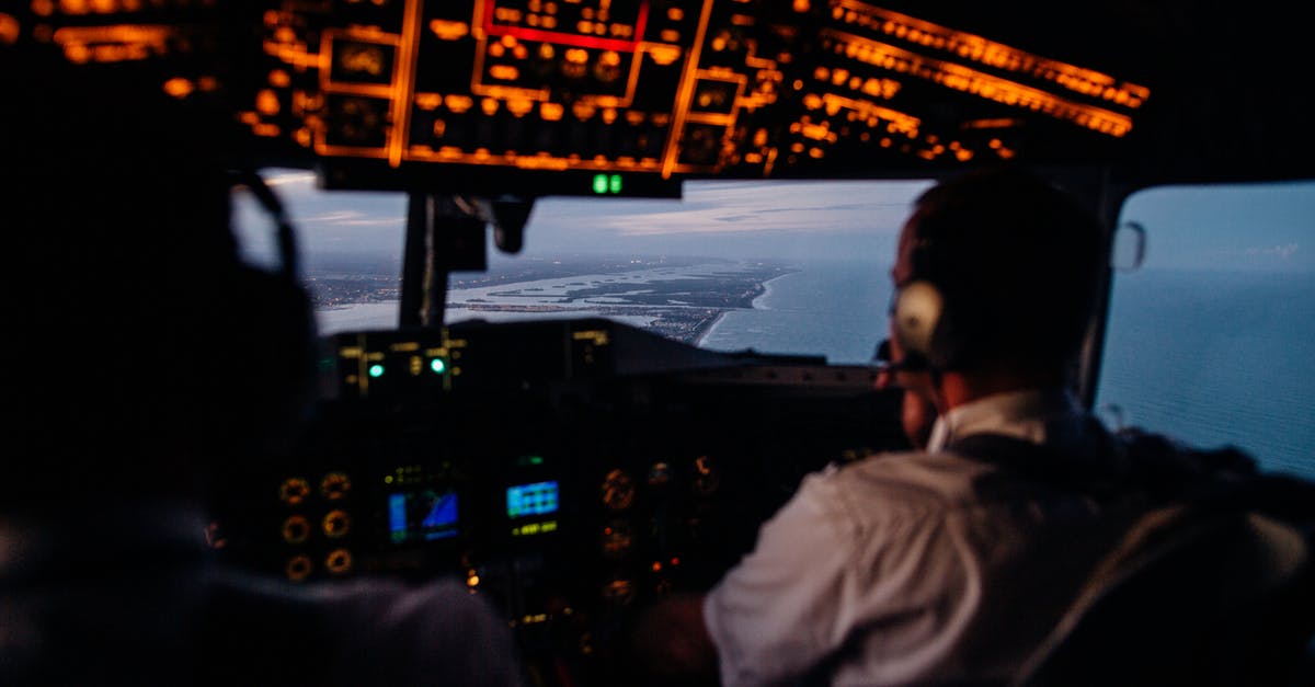 Getting back to Heathrow for an early flight - Anonymous pilots in aircraft cockpit flying over sea Getting back to Heathrow for an early flight - Anonymous pilots in aircraft cockpit flying over sea