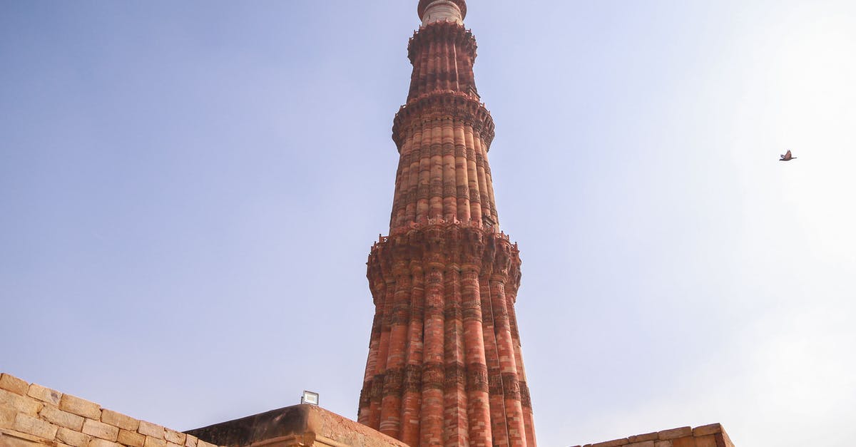 Getting from Delhi Airport to Delhi Cantt - From below of ancient ornamental brick tower of Qutb Minar against cloudless blue sky located in historic complex in Delhi Getting from Delhi Airport to Delhi Cantt - From below of ancient ornamental brick tower of Qutb Minar against cloudless blue sky located in historic complex in Delhi