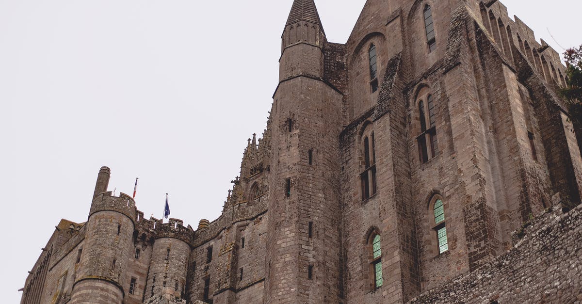 Getting from Fort Collins to Denver Amtrak - Brick Gothic abbey castle against gray sky Getting from Fort Collins to Denver Amtrak - Brick Gothic abbey castle against gray sky